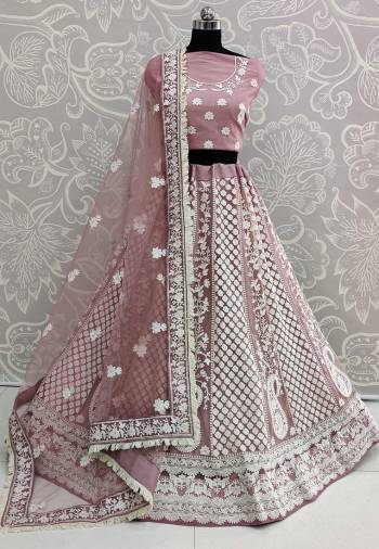 Flaunt Your Rich And Elegant In This New Patterned Heavy Designer Lehenga Choli In Dusty Pink Color. Its Heavy Embroidered Blouse, Lehenga And Dupatta Are Fabricated On Net Beautified With White Colored Thread Embroidery Giving An Attractive Look. 