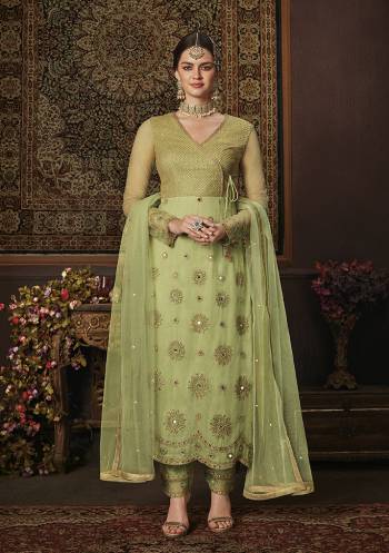 Add This Pretty Shade To Your Wardrobe With This Heavy Designer Straight Suit In Light Green Color. Its Embroidred Top And Dupatta Are Net Based Paired With Soft Silk Bottom. Buy Now.