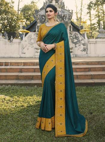 Add This Beautiful Designer Saree To Your Wardrobe In Teal Blue Color Paired With Contrasting Musturd Yellow Colored Blouse. This Saree Is Fabricated On Chinon Chiffon Paired With Art Silk Fabricated Blouse. Buy This Lovely Colored Saree Now. 
