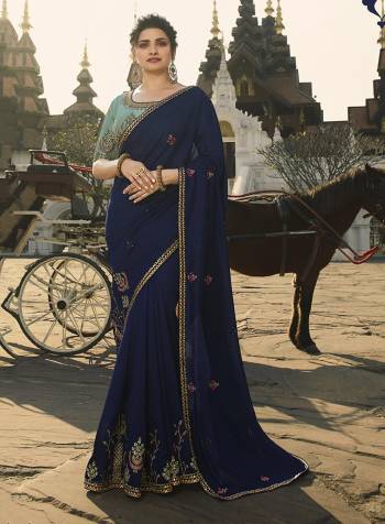 Enhance Your Personality Wearing This Designer Saree In Navy Blue Color Paired With Turquoise Blue Colored Blouse. This Saree Is Fabricated On Crepe Silk Paired With Art Silk Fabricated Blouse. 
