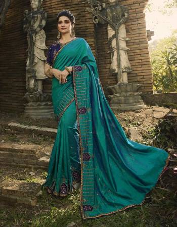 Go With Lovely Shades Of Blue Color With This Designer Saree In Blue Color Paired With Navy Blue Colored Blouse. This Saree Is Fabricated On Raw Silk Paired With Art Silk Fabricated Blouse. It Is Beautified With Attractive Embroidered Lace Border And Heavy Embroidered Blouse. 