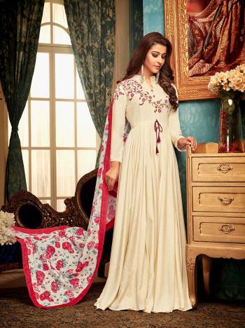 Flaunt Your Rich and Elegant Taste Wearing This Designer Readymade Gown In Cream Color Paired With White And Pink Colored Dupatta. This Pretty Set Of Gown And Dupatta Are Fabricated On Muslin Beautified With Prints And Embroidery. 