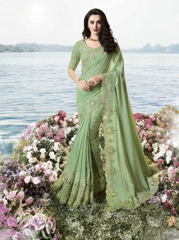 Look Pretty In This  Heavy Designer Saree In Green Color Paired With Green Colored Blouse. This Saree Is Fabricated On Tissue Silk Paired With Art Silk And Net Fabricated Blouse. It Is Beautified With Heavy Embroidered Attractive Lace Border. 