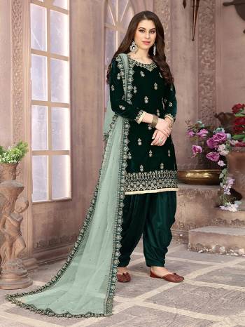 Get Ready For The Upcoming Festive And Wedding Season With This Designer Patiala Suit In Pine Green Color Paired With Pastel Green Colored Dupatta. Its Embroidered Top Is Fabricated On Velvet Paired With Santoon Bottom And Net Fabricated Embroidered Dupatta. It Is Light Weight And Easy To Carry Throughtout The Gala. Buy this Semi-Stitched Suit Now.