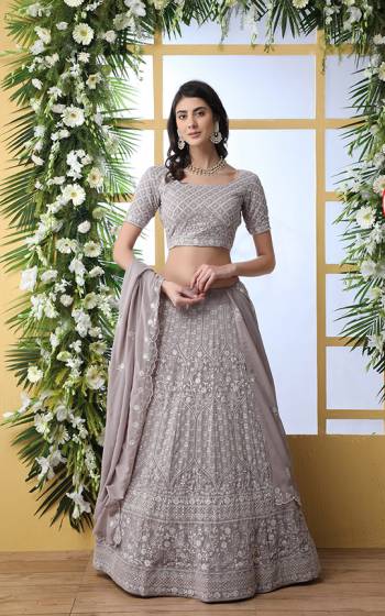 Flaunt Your Rich And Elegant Taste Wearing This Heavy Designer Lehenga Choli In Light Grey Color. This Pretty Tone To Tone Embroidered Lehenga Choli Is Georgette Based. It Has Lovely Tone To Tone Embroidery With Sequence Work Giving A Heavy Yet Subtle Look. Buy Now.