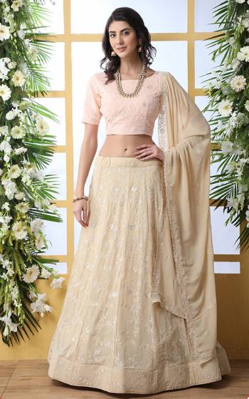 Flaunt Your Rich And Elegant Taste Wearing This Heavy Designer Lehenga Choli In Peach Colored Blouse Paired With Light Beige Colored Bottom And Dupatta. This Pretty Lehenga Choli Is Georgette Based. It Has Lovely Embroidery With Resham Embroidery With Sequence Work Giving A Heavy Yet Subtle Look. Buy Now.