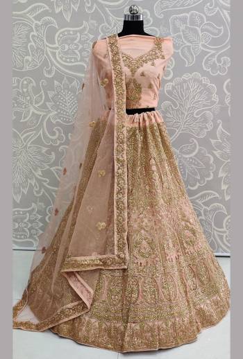 This Wedding Season Be The Most Trendiest Diva Wearing This Heavy Designer Lehenga Choli In Peach Color. Its Pretty And Detailed Heavy Embroidered Blouse, Lehenga And Dupatta Are Fabricated On Net. Its Pretty Color And Detailed Embroidery Will Earn You Lots Of Compliments From Onlookers. 