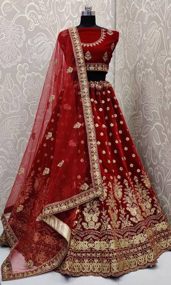 Every Womens Favourite Color In Lehenga Is Here In Maroon Color. This Heavy designer Maroon Colored lehenga Choli IS Velvet Based Paired With Net Fabricated Dupatta. Its royal Color And Embroidery Will Earn You Lots Of Compliments From Onlookers. 