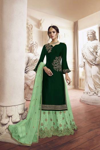 Grab This Very Beautiful Designer Sharara Suit In Dark Green Colored Top Paired With Light Green Colored Bottom And Dupatta. Its Top Is Fabricated On Georgette Paired With Net Fabricated Bottom and Dupatta. It Has Detailed Pretty Embroidery Giving An Attractive Look. 