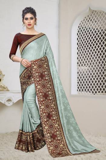 Celebrate This Festive Season With This Designer Elegant Saree In Steel Grey Color Paired With Contrasting Maroon Colored Blouse. This Saree Is Fabricated On Jacquard Silk Paired With Art Silk Fabricated Blouse. Its Broad Border Is Beautified With Heavy Jari & Stone Work. 