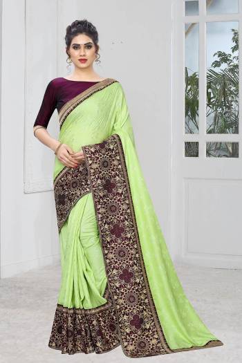 Celebrate This Festive Season With This Designer Elegant Saree In Mint Green Color Paired With Contrasting Wine Colored Blouse. This Saree Is Fabricated On Jacquard Silk Paired With Art Silk Fabricated Blouse. Its Broad Border Is Beautified With Heavy Jari & Stone Work. 