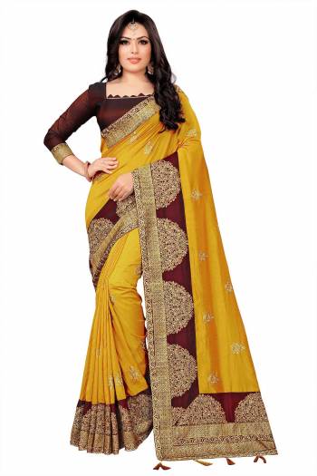 Look Attractive In This Pretty Embroidered Designer Saree In Musturd Yellow Color Paired With Maroon colored Blouse. This Saree Is Silk Based Paired With Tafeta Art Silk Fabricated Blouse. 