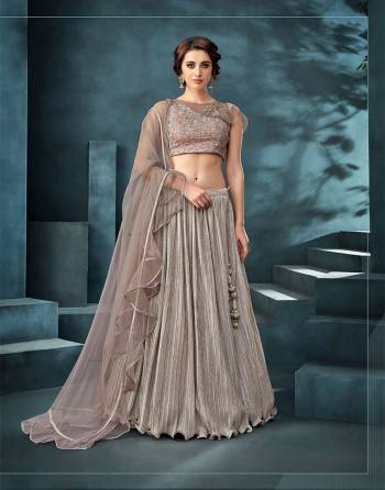 This contemporary lehenga sprinkled with Shimmery crush and delicate frills is a perfect combination to boost your youthful energy. Combine with your favourite glimmering fashion jewelry for a fashionista appeal. 