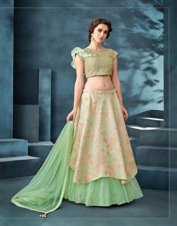 Weave magic in subtle and pretty pastel shades , asymmetric cuts and ruffles in this two-layered lehenga . Couple it up with huge statement making earrings for a bewitching appeal.