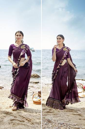 Add This Trendy Designer Ruffle Saree To Your Wardrobe In Wine Color. This Pretty Saree Is Fabricated On Lycra Paired With Art Silk Fabricated Blouse. It Is Beautified With Pretty Ruffles And Hand Embroidered Patch Work. 