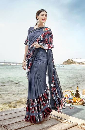 Add This Trendy Designer Ruffle Saree To Your Wardrobe In Grey Color. This Pretty Saree Is Fabricated On Lycra Paired With Art Silk Fabricated Blouse. It Is Beautified With Pretty Ruffles And Hand Embroidered Patch Work. 