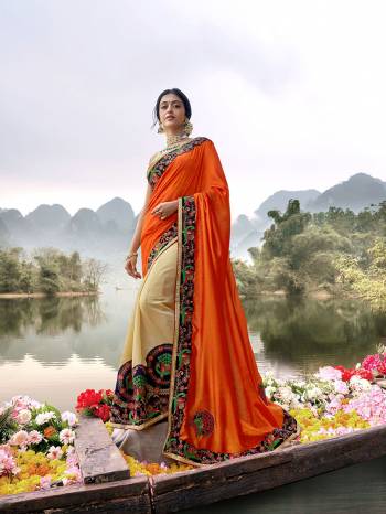 Shine Bright In This Lovely Designer Saree In Orange And Cream Color Paired With Cream Colored Blouse. This Saree Is Fabricated On Vichitra Silk Paired With Art Silk Fabricated Blouse. Buy This Saree Now.