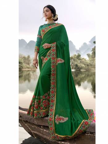 Celebrate This Festive Season Wearing This Pretty Saree In Green Color Paired With Teal Blue Colored Blouse. This Saree And Blouse Are Silk Based Which Also Gives A Rich Look To Your Personality. Buy Now.