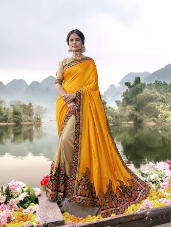 Shine Bright In This Lovely Designer Saree In Musturd Yellow And Cream Color Paired With Cream Colored Blouse. This Saree Is Fabricated On Vichitra Silk Paired With Art Silk Fabricated Blouse. Buy This Saree Now.