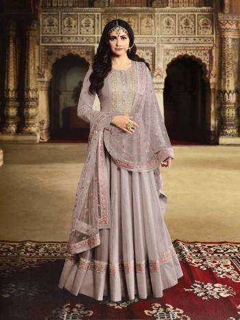 Get Ready For The Upcoming Wedding And Festive Season With This Heavy Designer Floor Length Suit In Grey Color. Its Embroidered Top Is Fabricated On Georgette Paired With Santoon Bottom And Net Fabricated Embroidered Dupatta. 