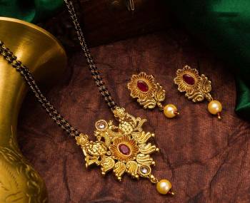 Grab This Heavy Double Chained Traditional Patterned Magalsutra Set Which Has A Heavy Designer Attatched Pendant With A Pair Of Earrings. This Mangalsutra Can Be Paired With Any Colored Traditional Attire And Suitable For Occasion Wear. Buy Now