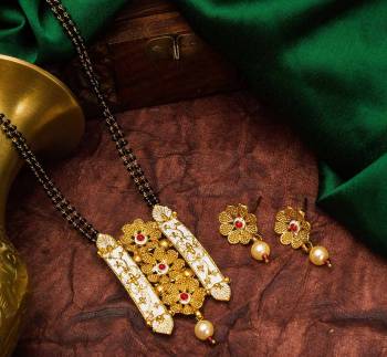 Grab This Heavy Double Chained Traditional Patterned Magalsutra Set Which Has A Heavy Designer Attatched Pendant With A Pair Of Earrings. This Mangalsutra Can Be Paired With Any Colored Traditional Attire And Suitable For Occasion Wear. Buy Now