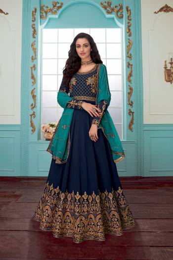 Get Ready For The Upcoming Wedding Season With This Designer Floor Length Suit In Navy Blue Color Paired With Blue Colored Dupatta. Its Embroidered Top And Dupatta Are Georgette Based Paired With Santoon Fabricated Bottom. Buy Now.