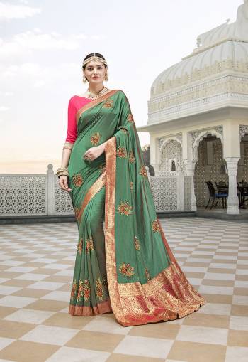 Attract All Wearing This Designer Saree In Green Color Paired With Contrasting Pink Colored Blouse. This Saree Is Fabricated On Satin Silk Paired With Art Silk Fabricated Blouse. It Is Beautified With Embroidered Motifs And Lace Border. 