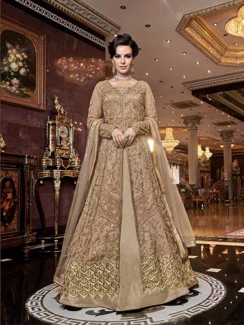 Rich And Elegant Looking Designer Indo-Western Suit Is Here In Beige Which Comes With Two Bottoms. Its Heavy Embroidered Top Is Fabricated On Net Paired With Satin Fabricated Embroidered Bottom , A Satin Fabricated Lehenga And Net Fabricated Dupatta. All Its Fabrics Are Light Weight And Easy To Carry Throughout The Gala.