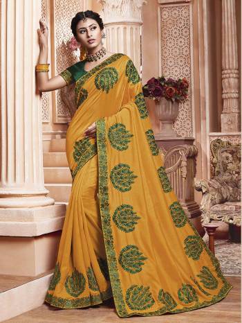 Get Ready For The Upcoming Wedding And Festive Season With This Designer Saree In Yellow Color Paired With Contrasting Green Colored Blouse. This Contrasting Embroidered Saree Is Fabricated On Vichitra Silk Paired With Art Silk Fabricated Blouse.