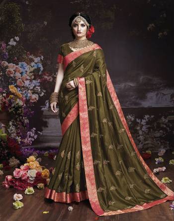 Get Ready For The Upcoming Wedding And Festive Season With This Designer Saree In Olive Green Color. This Attractive Jari Embroidered Saree Is Fabricated On Vichitra Silk Paired With Vichitra Silk Fabricated Blouse. It Is Beautified With Broad Lace Border With Stone Work. Buy Now.