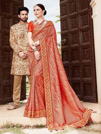 For A Proper Traditional Look, Grab This Heavy Designer Saree In Red Color Paired With Contrasting Orange Colored Blouse. This Saree Is Fabricated On Jacquard Silk Paired With Art Silk Fabricated Blouse. It Is Beautified With Heavy Embroidered Lace Border And Blouse. 