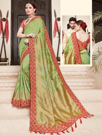 For A Proper Traditional Look, Grab This Heavy Designer Saree In Green Color Paired With Contrasting Peach Colored Blouse. This Saree Is Fabricated On Jacquard Silk Paired With Art Silk Fabricated Blouse. It Is Beautified With Heavy Embroidered Lace Border And Blouse. 