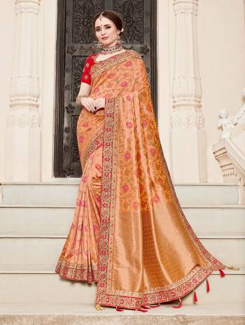 For A Proper Traditional Look, Grab This Heavy Designer Saree In Peach Color Paired With Contrasting Red Colored Blouse. This Saree Is Fabricated On Jacquard Silk Paired With Art Silk Fabricated Blouse. It Is Beautified With Heavy Embroidered Lace Border And Blouse. 