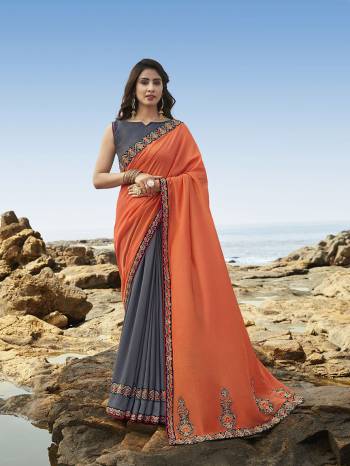 Celebrate this Festive Season Wearing This Attractive Heavy Designer Saree In Orange & Dark Grey Color Paired With Dark Grey Colored Blouse. This Saree Is Soft Silk Based Which Gives A Rich Look To Your Personality.  