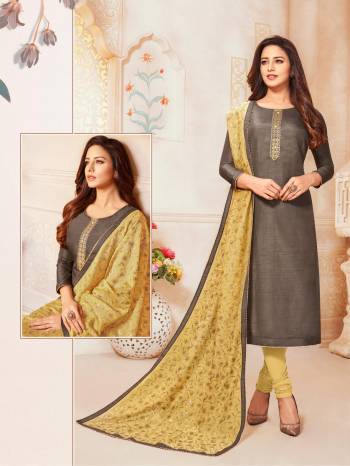 Here Is A Rich And Elegant Looking Designer Straight Suit In Dark Grey Colored Top Paired With Contrasting Occur Yellow Colored Bottom And Dupatta. Its Top Is Fabricated On Soft Silk Paired With Cotton Bottom And Modal Silk Dupatta. 