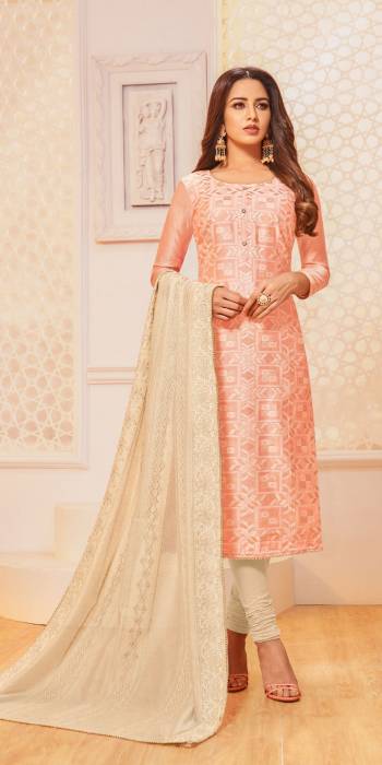 For Your Semi-Casual Wear, Grab This Pretty Semi-Stitched Suit In Light Peach Colored Top Paired With Cream Colored Bottom And Dupatta. Its Top Is Fabricated On Jacquard Silk Paired With Cotton Bottom And Chanderi Silk Dupatta. 