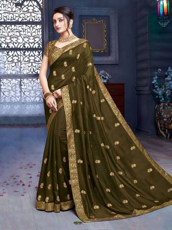 Grab This Pretty Attractive Saree In Olive Green Color. This Saree Is Fabricated On Art Silk Paired With Brocade Fabricated Blouse. Its Rich Fabric And Color Will Earn You Lots Of Compliments From Onlookers.