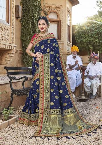 For A Royal Look, Grab This Designer Saree In Navy Blue Color Paired With Contrasting Dark Pink Colored Blouse. This Saree Is Fabricated On Satin Jacquard Silk Paired With Art Silk Fabricated Blouse. It Is Beautified With Attractive Embroidered Lace Border And Blouse. 