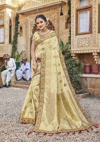 For A Royal Look, Grab This Designer Saree In Cream Color Paired With Cream Colored Blouse. This Saree Is Fabricated On Satin Jacquard Silk Paired With Art Silk Fabricated Blouse. It Is Beautified With Attractive Embroidered Lace Border And Blouse. 