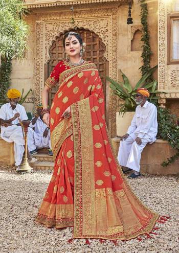 For A Royal Look, Grab This Designer Saree In Orange Color Paired With Contrasting Red Colored Blouse. This Saree Is Fabricated On Satin Jacquard Silk Paired With Art Silk Fabricated Blouse. It Is Beautified With Attractive Embroidered Lace Border And Blouse. 