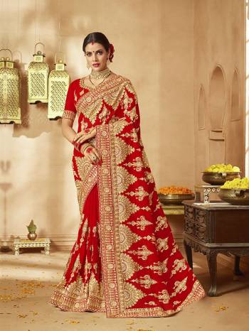 Here Is A Very Attractive Heavy Designer Bridal Saree For The Upcoming Wedding Season In Red Color Paired With Embroidered Red Colored Blouse. It Is Beautified With Heavy Jari Embroidery With Stone Work. Buy This Lovely Bridal Saree Now.