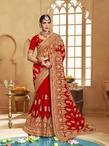 Here Is A Very Attractive Heavy Designer Bridal Saree For The Upcoming Wedding Season In Red Color Paired With Embroidered Red Colored Blouse. It Is Beautified With Heavy Jari Embroidery With Stone Work. Buy This Lovely Bridal Saree Now.