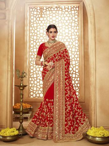 Here Is A Very Attractive Heavy Designer Bridal Saree For The Upcoming Wedding Season In Red Color Paired With Embroidered Red Colored Blouse. It Is Beautified With Heavy Jari Embroidery With Stone Work. Buy This Lovely Bridal Saree Now.