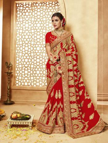 Here Is A Very Attractive Heavy Designer Bridal Saree For The Upcoming Wedding Season In Red Color Paired With Embroidered Red Colored Blouse. It Is Beautified With Heavy Jari Embroidery With Stone Work. Buy This Lovely Bridal Saree Now.