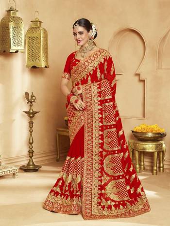 Here Is A Very Attractive Heavy Designer Bridal Saree For The Upcoming Wedding Season In Red Color Paired With Embroidered Red Colored Blouse. It Is Beautified With Heavy Jari Embroidery With Stone Work. Buy This Lovely Bridal Saree Now.