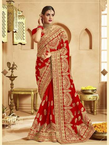 Here Is A Very Attractive Heavy Designer Bridal Saree For The Upcoming Wedding Season In Red Color Paired With Embroidered Red Colored Blouse. It Is Beautified With Heavy Jari Embroidery With Stone Work. Buy This Lovely Bridal Saree Now.