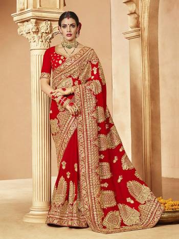 Here Is A Very Attractive Heavy Designer Bridal Saree For The Upcoming Wedding Season In Red Color Paired With Embroidered Red Colored Blouse. It Is Beautified With Heavy Jari Embroidery With Stone Work. Buy This Lovely Bridal Saree Now.