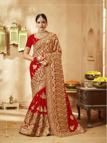 Here Is A Very Attractive Heavy Designer Bridal Saree For The Upcoming Wedding Season In Red Color Paired With Embroidered Red Colored Blouse. It Is Beautified With Heavy Jari Embroidery With Stone Work. Buy This Lovely Bridal Saree Now.