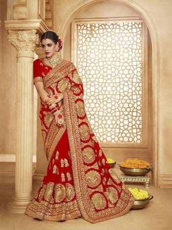 Here Is A Very Attractive Heavy Designer Bridal Saree For The Upcoming Wedding Season In Red Color Paired With Embroidered Red Colored Blouse. It Is Beautified With Heavy Jari Embroidery With Stone Work. Buy This Lovely Bridal Saree Now.